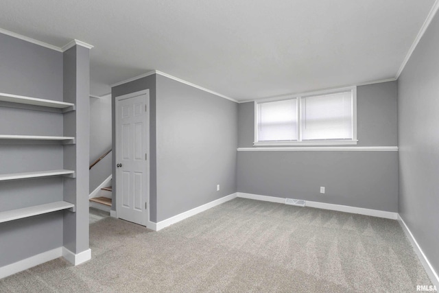 interior space featuring baseboards, carpet floors, visible vents, and crown molding