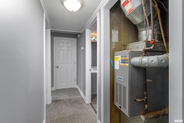 corridor with ornamental molding, carpet, and baseboards