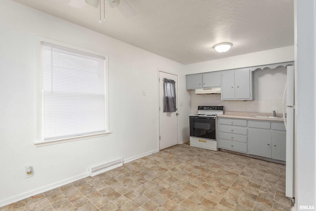 kitchen with white appliances, visible vents, gray cabinets, under cabinet range hood, and a sink