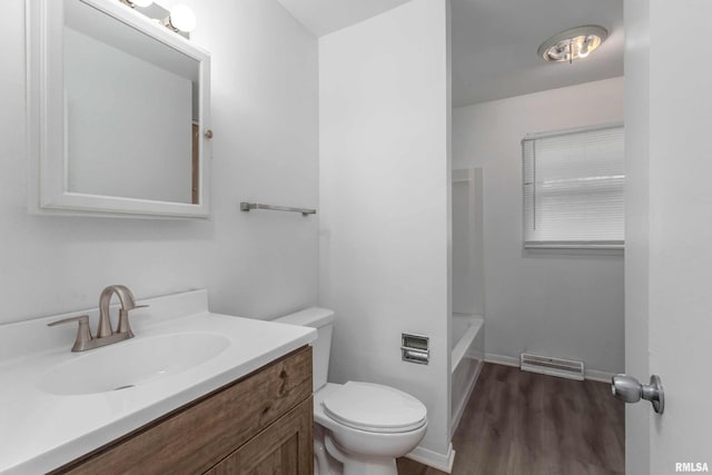 full bathroom with toilet, wood finished floors, vanity, visible vents, and baseboards