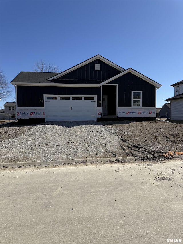 property in mid-construction featuring board and batten siding and an attached garage