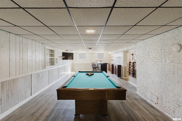 recreation room with a drop ceiling, billiards, and wood finished floors