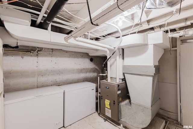 utility room featuring heating unit