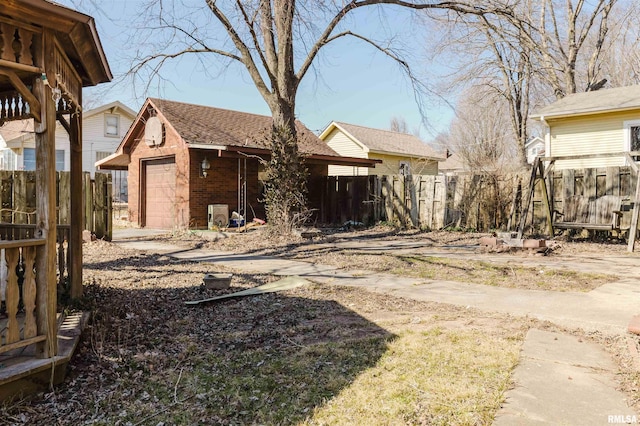 view of yard with a garage and fence