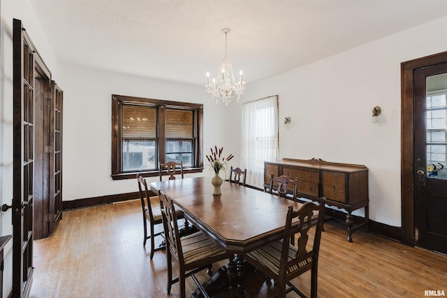 dining room with a healthy amount of sunlight, baseboards, and wood finished floors