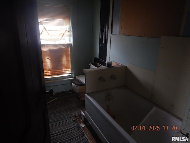 full bathroom with toilet and a tub