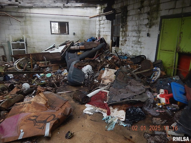 miscellaneous room with a garage and concrete block wall