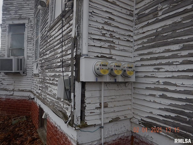 exterior details featuring electric meter and cooling unit