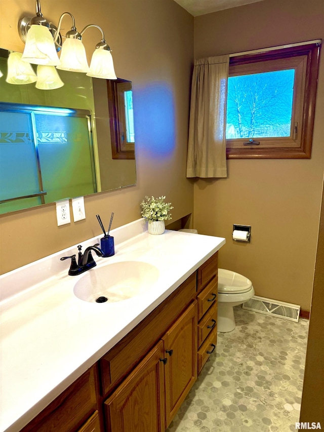 full bath featuring toilet, a stall shower, vanity, and visible vents