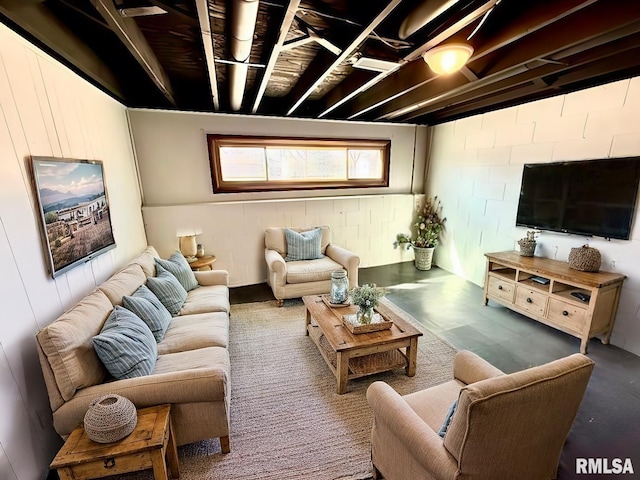 living area with concrete block wall