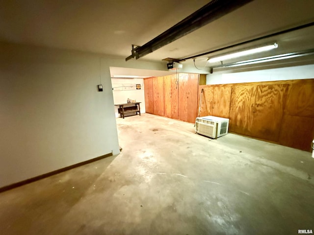 garage with baseboards and a garage door opener