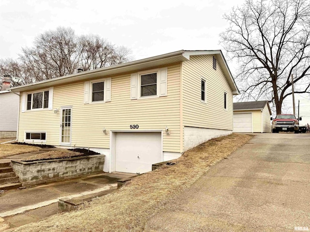 split foyer home with a garage and an outbuilding