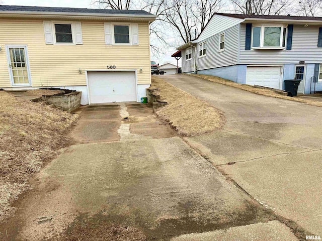 view of property exterior featuring a garage and concrete driveway