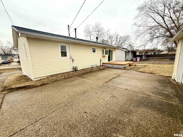 rear view of property featuring a patio area and a wooden deck