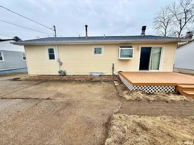 back of house featuring a deck and a patio area