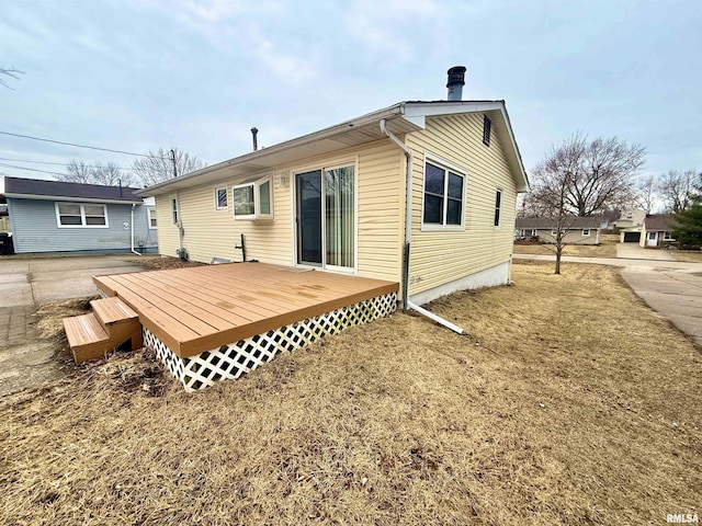 back of property featuring a deck