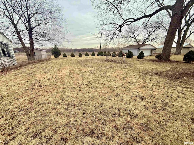 view of yard featuring fence and an outdoor structure