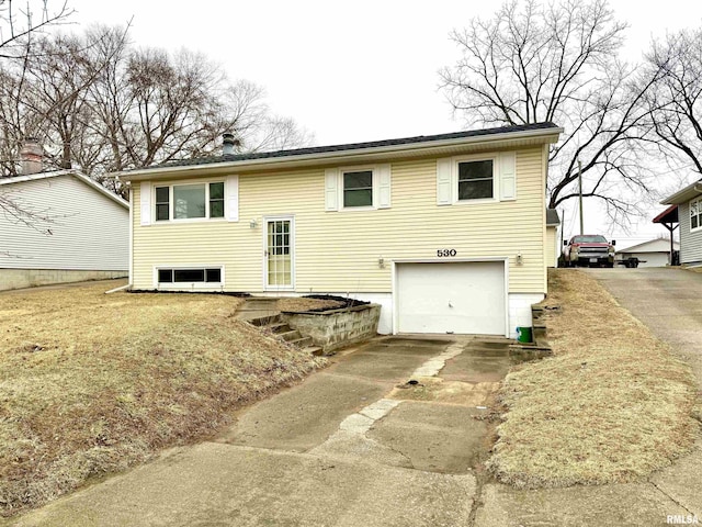 rear view of house with concrete driveway