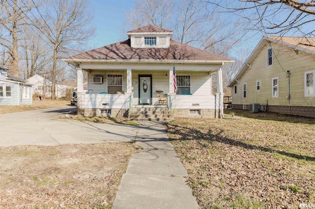 bungalow-style home featuring covered porch and central air condition unit