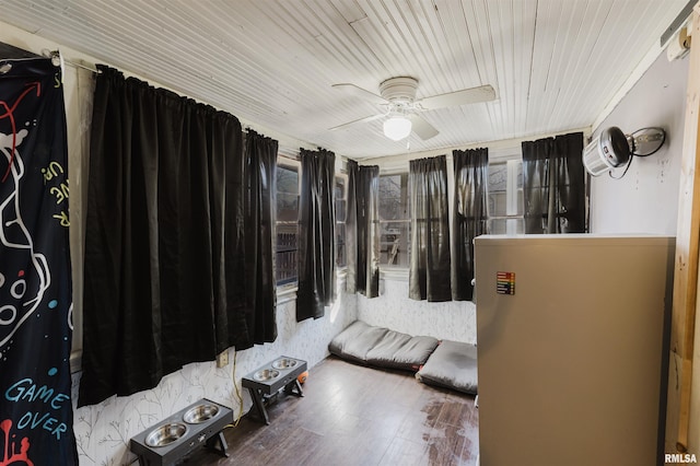 bedroom featuring ceiling fan, wood finished floors, and wood ceiling