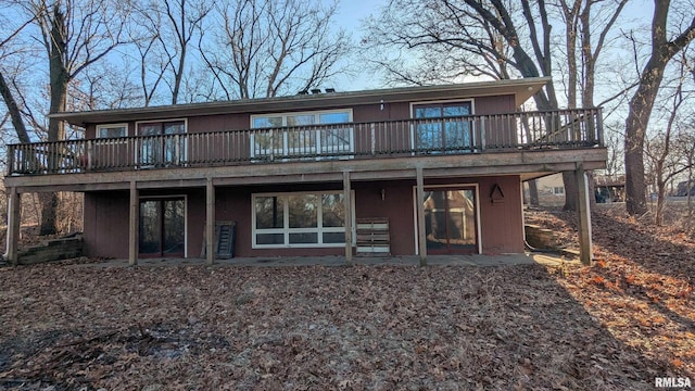 rear view of property with a wooden deck