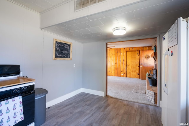 kitchen with baseboards, visible vents, and wood finished floors