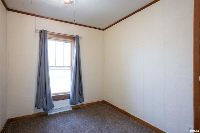 unfurnished room featuring carpet floors, ornamental molding, visible vents, and baseboards