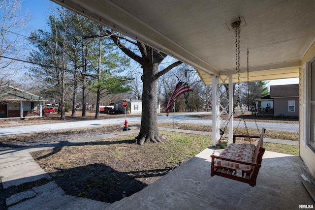 view of yard featuring covered porch