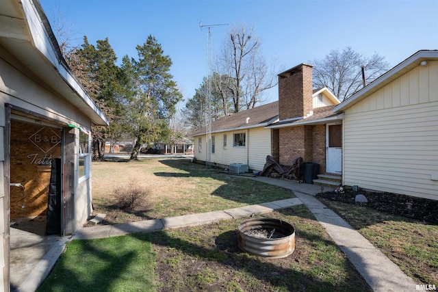 view of yard with entry steps and central AC unit