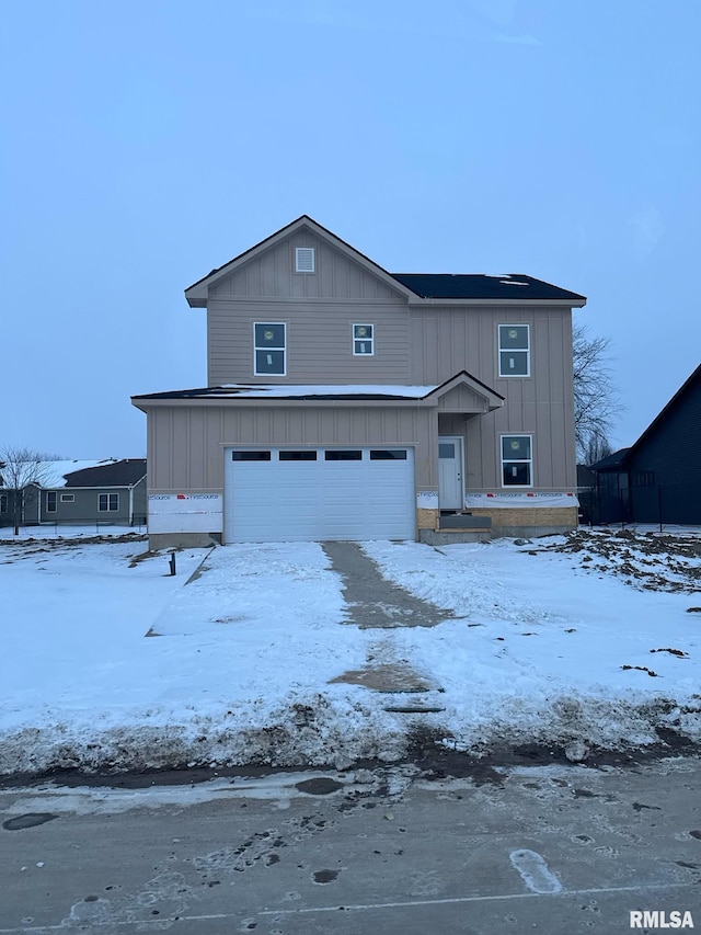 view of front facade with board and batten siding and an attached garage