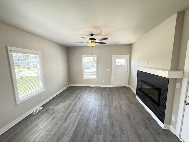 1631 Westport Dr, Davenport, IA 52804 - unfurnished living room with a glass covered fireplace, dark wood finished floors, and ceiling fan
