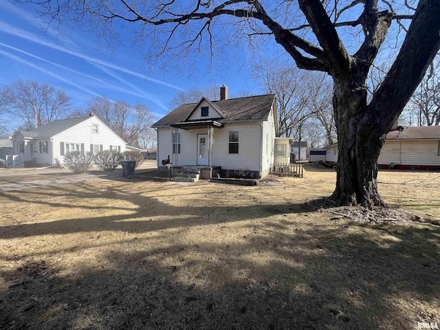 bungalow-style house with a chimney