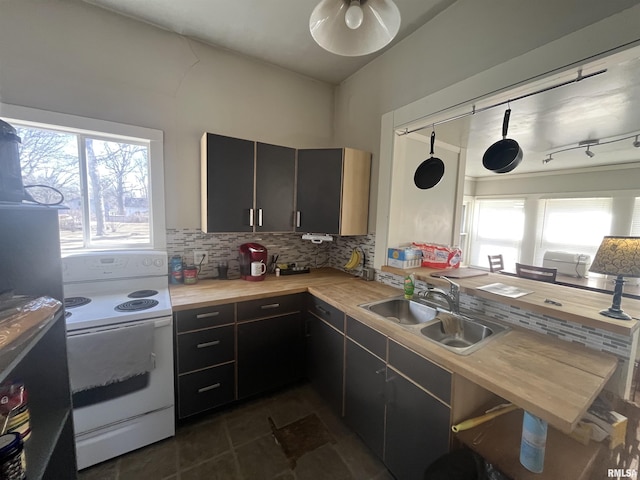 kitchen featuring white electric range oven, wood counters, decorative backsplash, and a sink