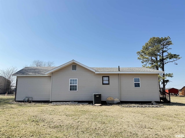 rear view of house featuring a lawn