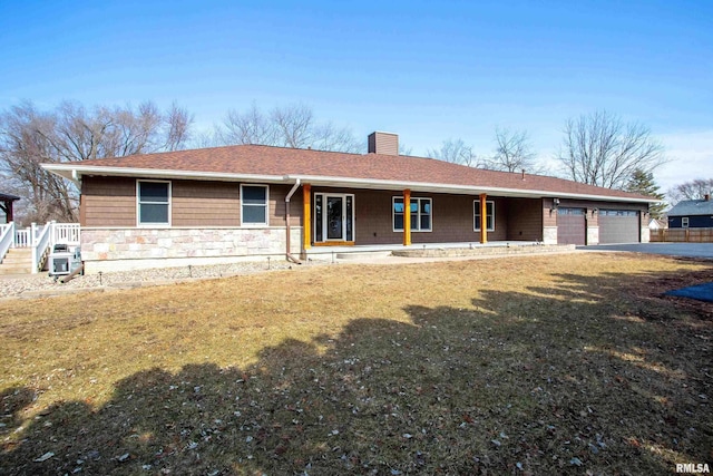 single story home featuring covered porch, a garage, a shingled roof, stone siding, and a chimney