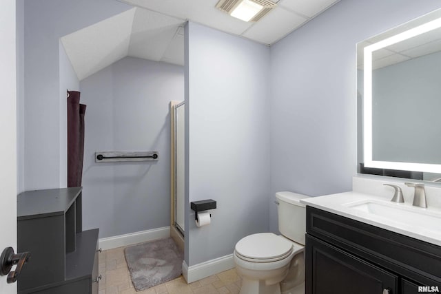 bathroom featuring toilet, a shower stall, baseboards, and vanity