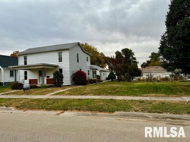 view of side of property with a yard