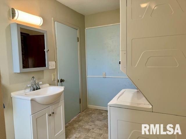 bathroom featuring washer / clothes dryer and vanity