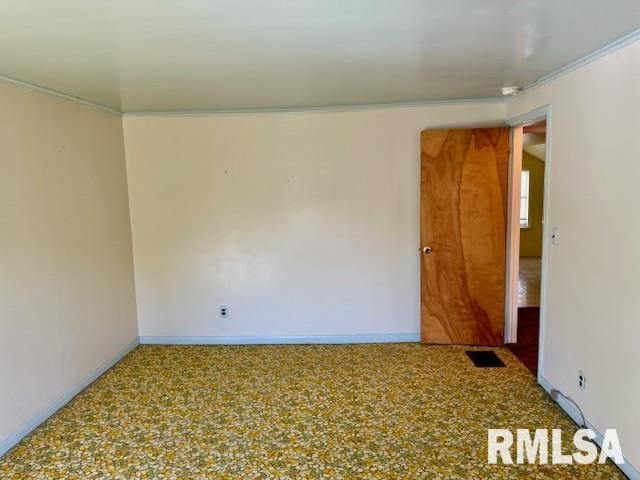 empty room with baseboards and visible vents