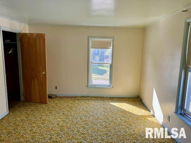 spare room with crown molding