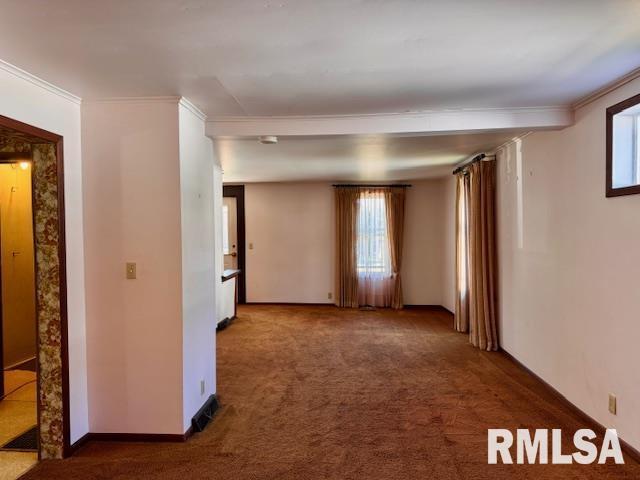 unfurnished room featuring carpet, ornamental molding, and baseboards