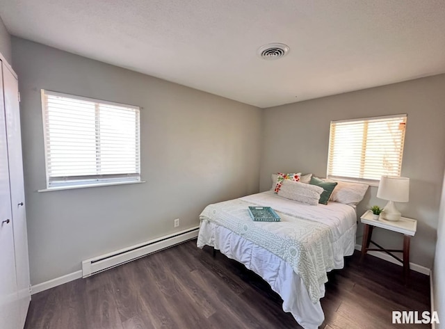 506 Timothy Ln, Carterville, IL 62918 - bedroom with baseboard heating, wood finished floors, and baseboards