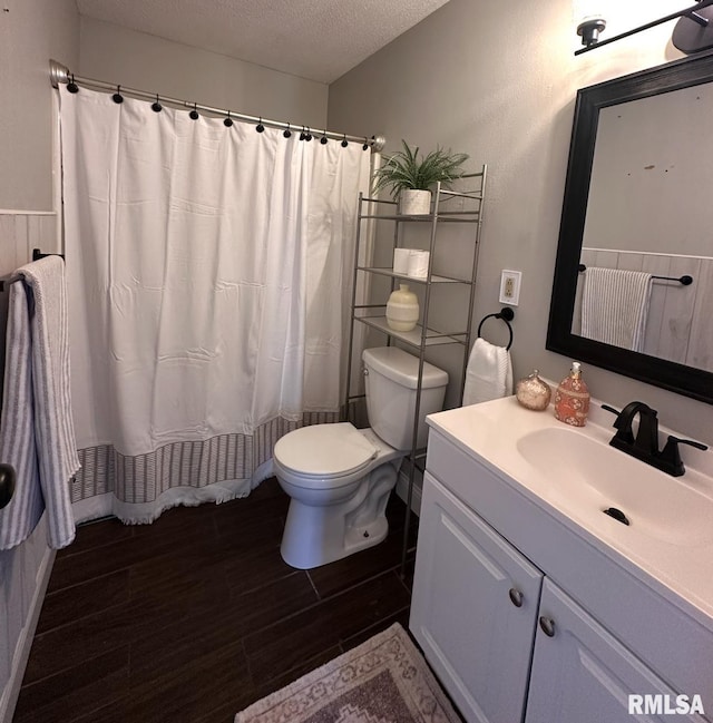 506 Timothy Ln, Carterville, IL 62918 - full bath with a textured ceiling, wood finished floors, toilet, vanity, and curtained shower