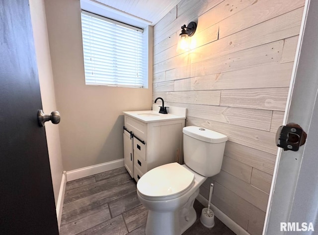 506 Timothy Ln, Carterville, IL 62918 - bathroom with wood walls, toilet, vanity, wood finished floors, and baseboards