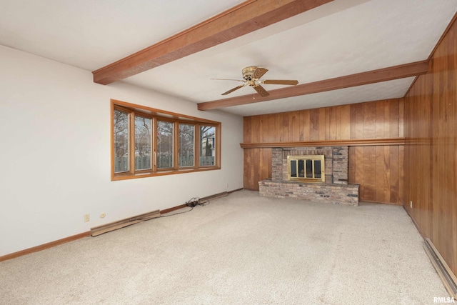 unfurnished living room featuring carpet, beam ceiling, wooden walls, and a brick fireplace