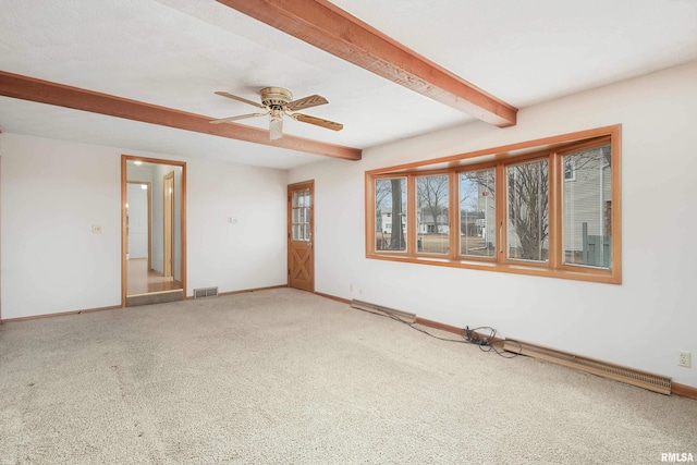 spare room with carpet, visible vents, a ceiling fan, beamed ceiling, and baseboards