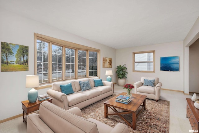 living room featuring carpet and baseboards