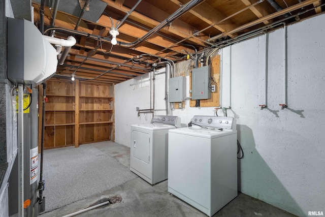 washroom featuring washing machine and dryer, laundry area, electric panel, and gas water heater