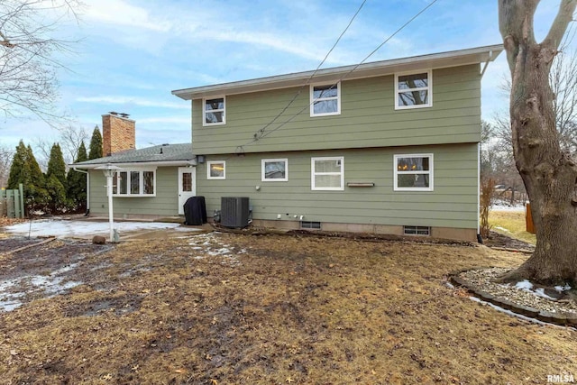 back of property featuring a chimney, central AC, and a patio