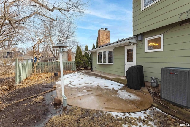 view of patio / terrace featuring fence and central AC unit